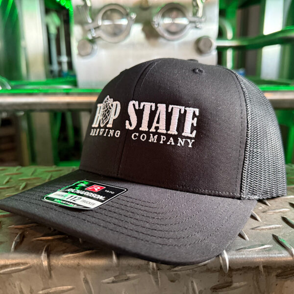 All Black Snap Back Trucker Style Hat with Embroidered Logo.